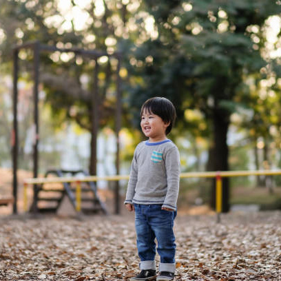 child-standing-on-autumn-leaves-picture-id1080887768.jpg